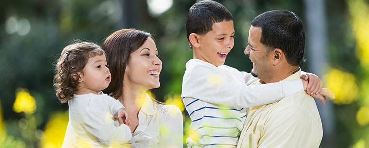 a family with kids in a field of flowers